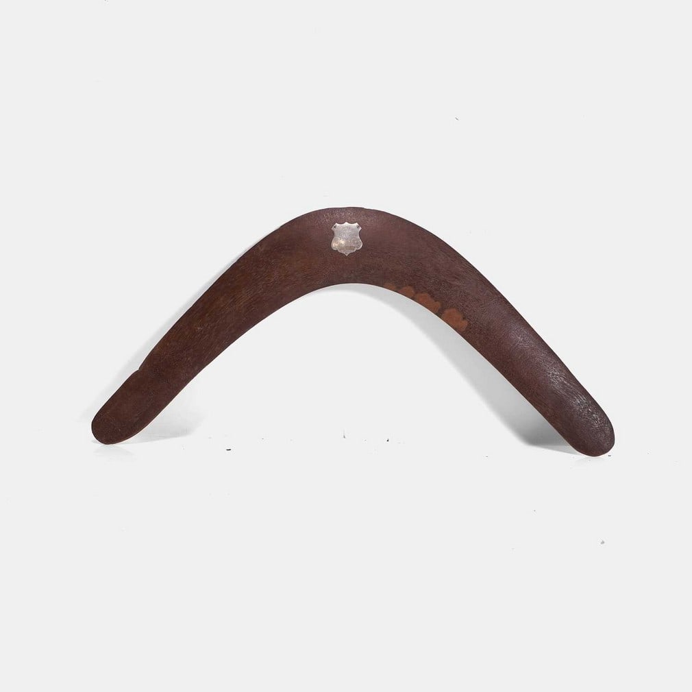 A rare named Aboriginal hardwood boomerang, circa 1900,: A rare named Aboriginal hardwood boomerang, circa 1900, of typical form, applied with a shield-shaped engraved silver plaque, inscribed 'From McIlroy Family Undera', stamped 'StgSil', with two metal