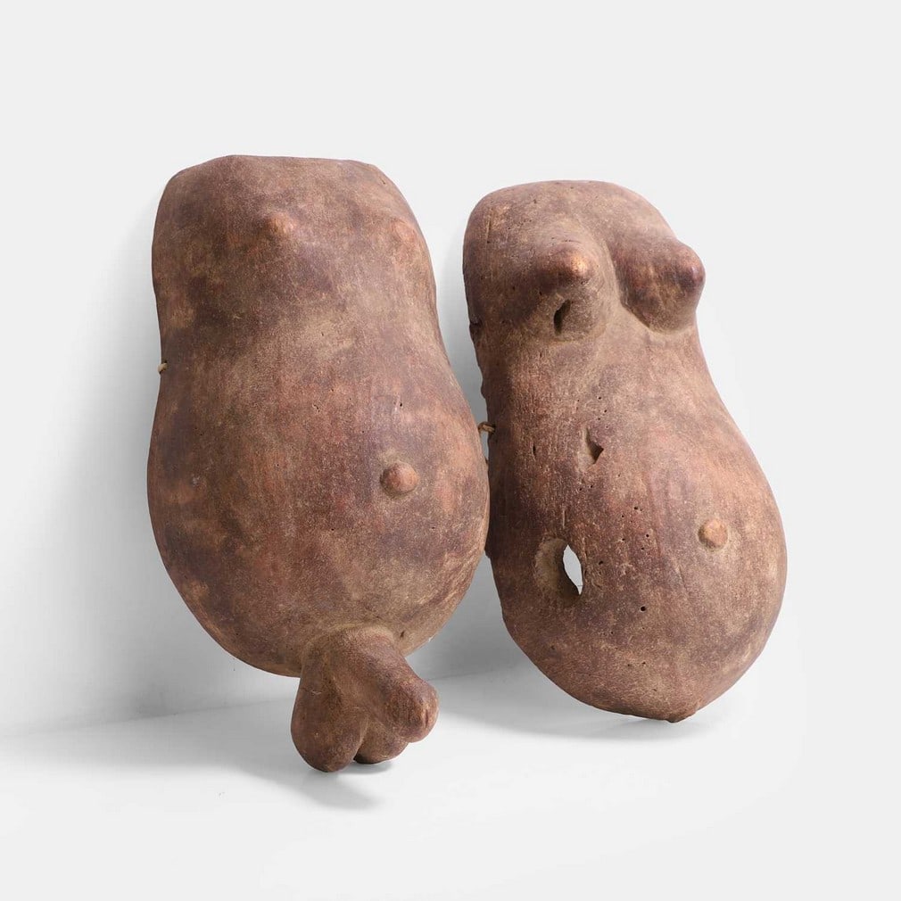 Two African male and female carved wood fertility body masks, 20th century, probably from Tanzania (1 of 2)