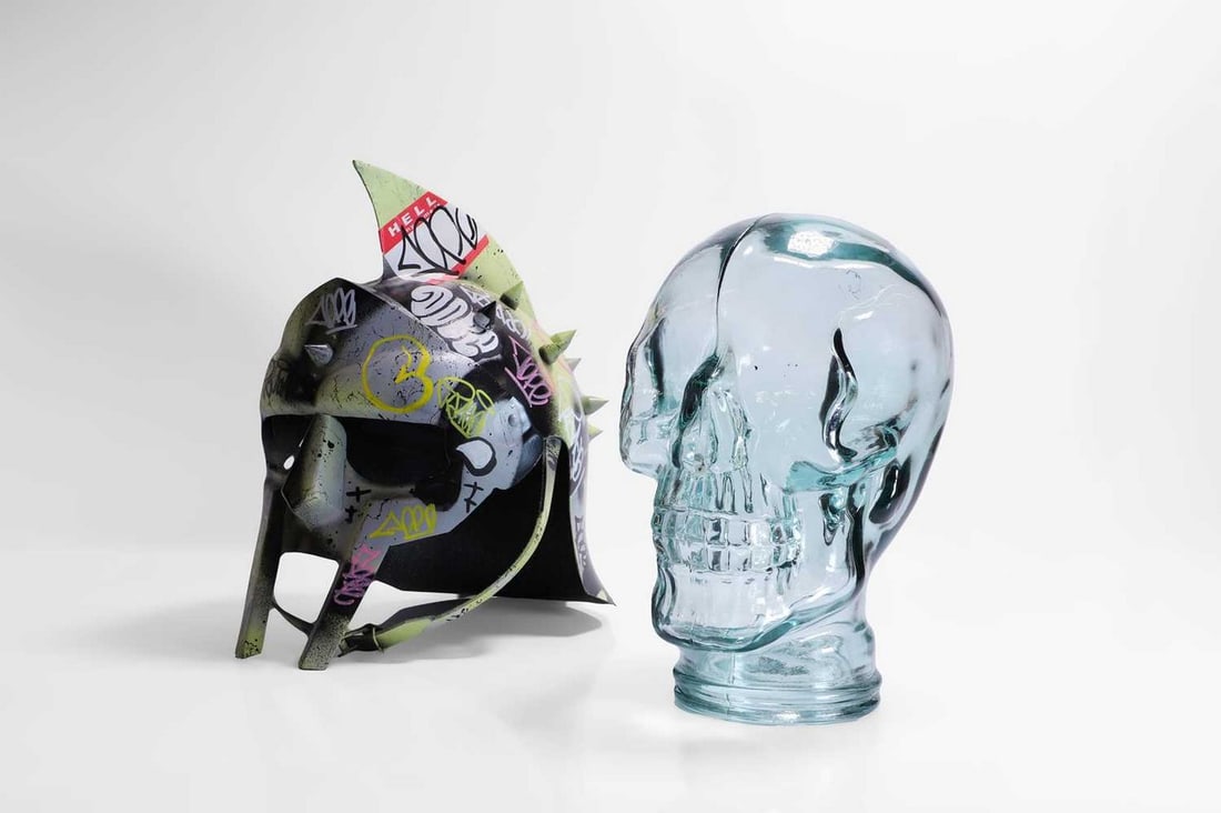 Zombiedan (contemporary) 20th century: Zombiedan (contemporary) 20th century Graffiti helmet and glass skull, mixed media sculpture (helmet 31cm high; skull 25cm high) (2) Condition Report: Both the helment and the glass skull appear to be