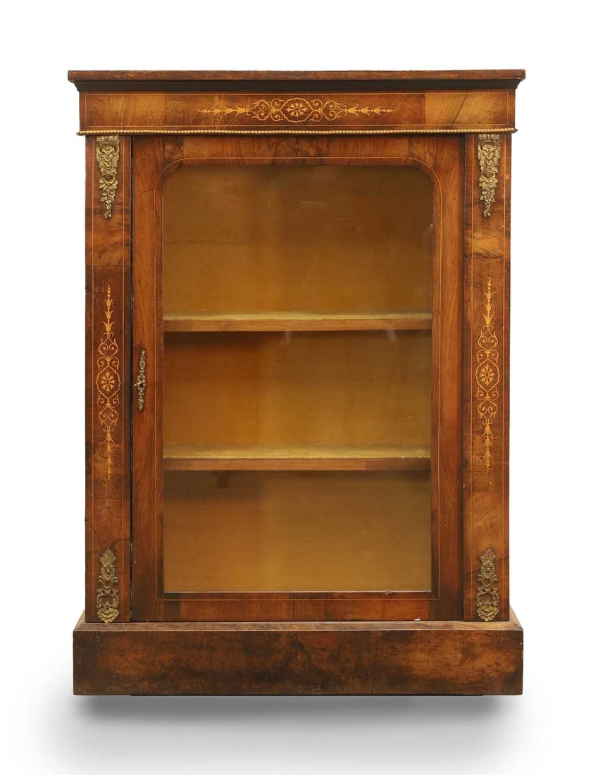 A Victorian inlaid mahogany pier cabinet, 19th century,: A Victorian inlaid mahogany pier cabinet, 19th century, with gilt detailing and masks, beaded surrounds and a glazed panel door, opening to reveal two shelves and a lined interior 75cm wide, 31cm
