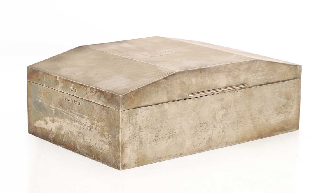 A large silver cigar case,: A large silver cigar case, by Harman Brothers, Birmingham, 1970, initialled 'N.A' with engine turned design, the interior with two wooden compartments 24cm wide, 16cm deep, 8.5cm high, total 52.20zt