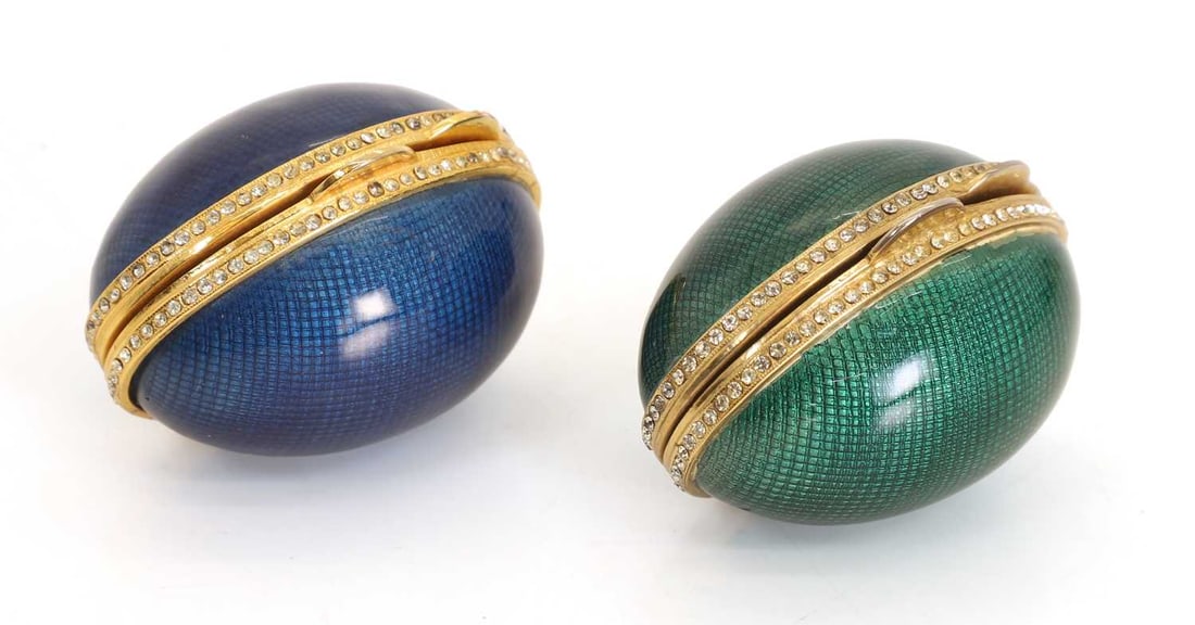 Two gilt brass, guilloché enamel and jewelled eggs, late 19th century,: Two gilt brass, guilloché enamel and jewelled eggs, late 19th century, with white interiors 5.3cm long each 2