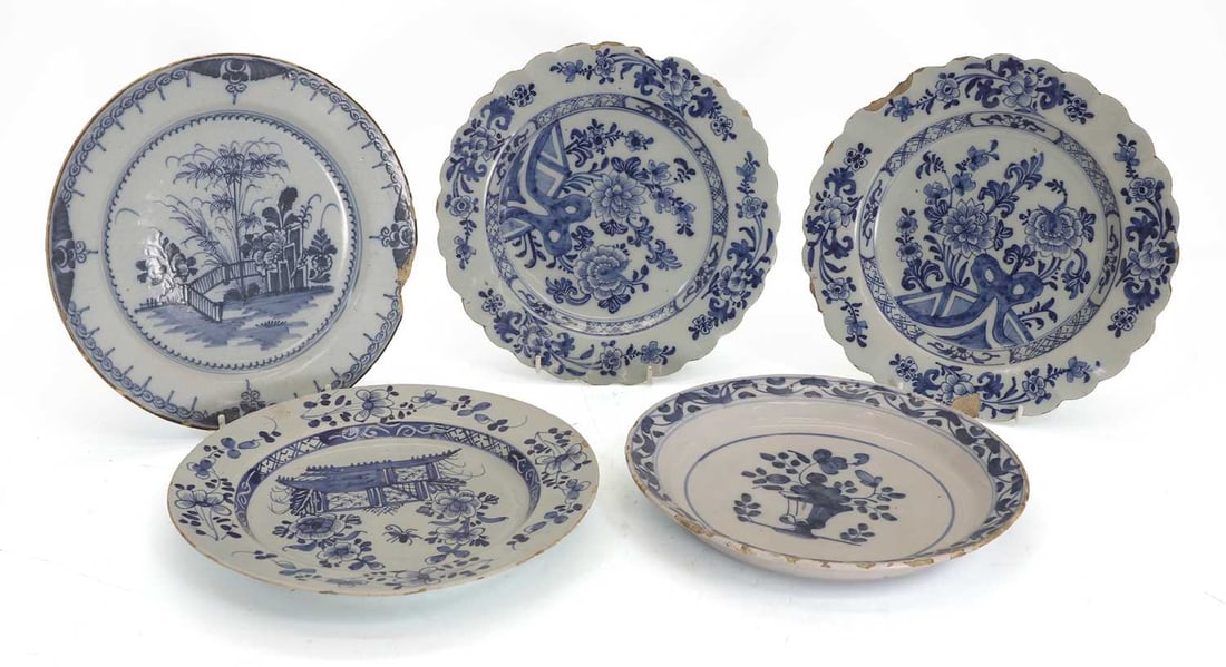 A pair of Delft plates, mid 18th century,: A pair of Delft plates, mid 18th century, with petal-shaped borders in the Chinese style, and three further Delft plates 23.5cm diameter 5 Condition Report: Chips and flakes to the edges of all.