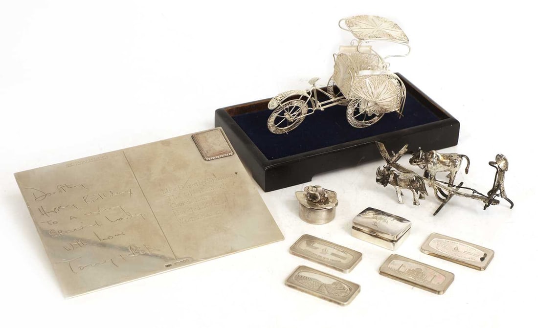 A modern silver postcard,: A modern silver postcard, by PJD, Edinburgh, 1999, four .800 silver Wonders of the World ingots by Singapore Airlines, two small silver pots and covers, one mounted with a frog, the other engraved wit