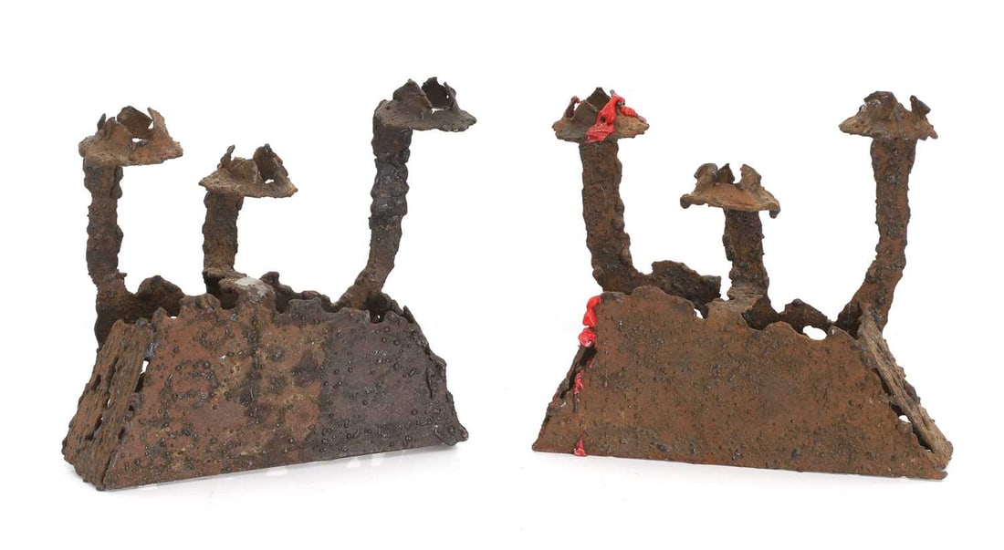 A pair of contemporary steel candelabras, 20th century,: A pair of contemporary steel candelabras, 20th century, naturalistically styled, each with three prongs, roughly modelled with weld spatter throughout 23.5cm wide, 6.5cm deep, 21cm high 2 Condition