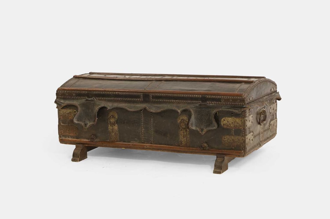 The Aldecoa family leather coach trunk, 19th century, Spanish,: The Aldecoa family leather coach trunk, 19th century, Spanish, bound with forged metal fittings and wooden fixtures, the hinged lid enclosing a void interior and painted storage compartment area, with