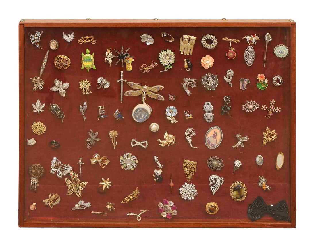 A display box of mid century and later costume brooches,: A display box of mid century and later costume brooches, to include a signed example with naturalistic style and blue stones, and a rolled gold example, an enamelled turtle, various other examples