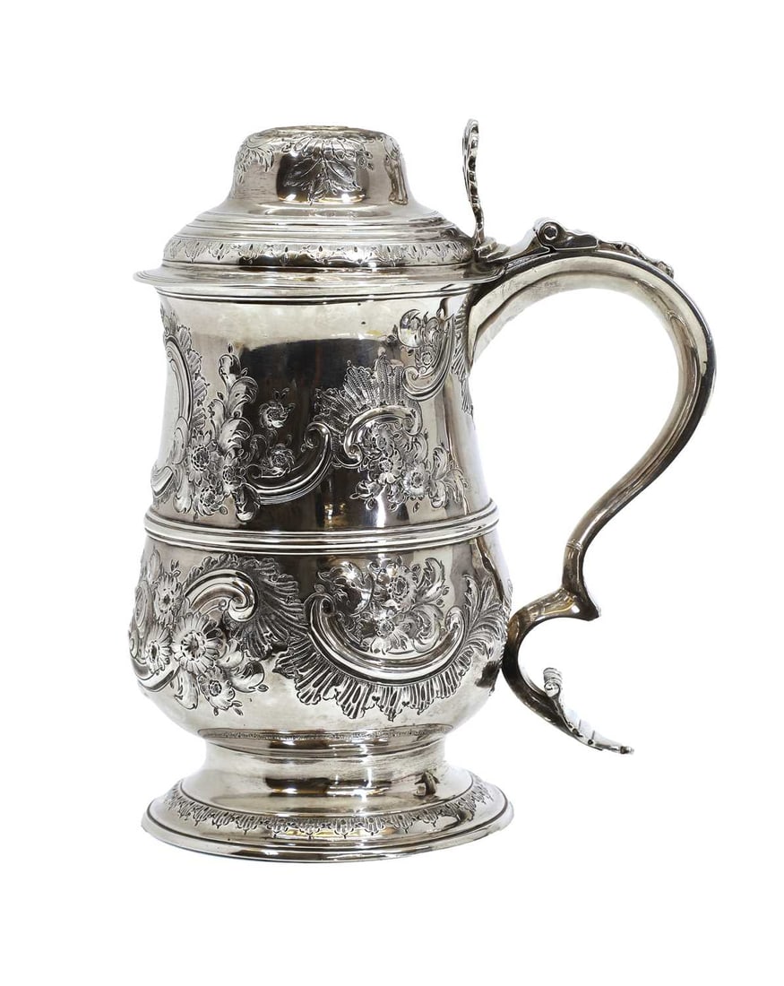 A George III silver tankard,: A George III silver tankard, by Peter & Ann Bateman, London 1793, with later chased decoration and floral repoussé design and vacant cartouche and scrolled thumb piece 18cm wide, 21cm high Co