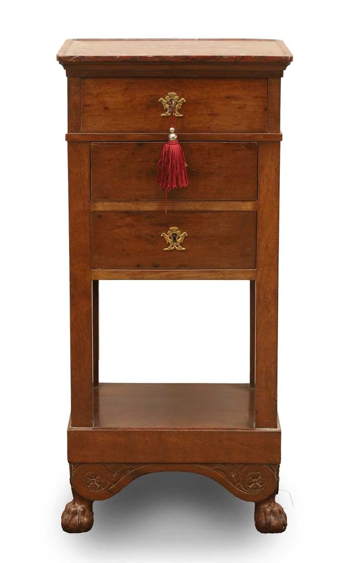 A French Empire mahogany cabinet, 19th century,: A French Empire mahogany cabinet, 19th century, with a raspberry marble top, three drawers with ormolu key escutcheons and key, with a small lower storage area W 28.5cm, D 33cm, H 81.7cm,