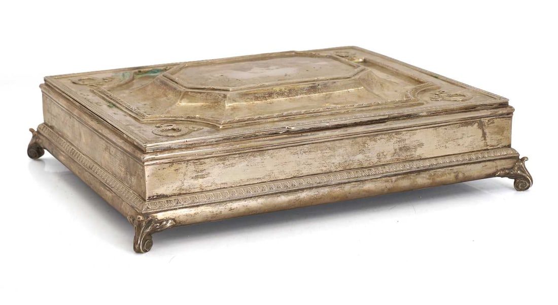 A large silver humidor,: A large silver humidor, marks rubbed, decorated with laurel wreaths and ribbon swags to the four corners, with wooden interior, terminating on scrolled feet 37.4cm wide, 31.5cm deep, 10cm high