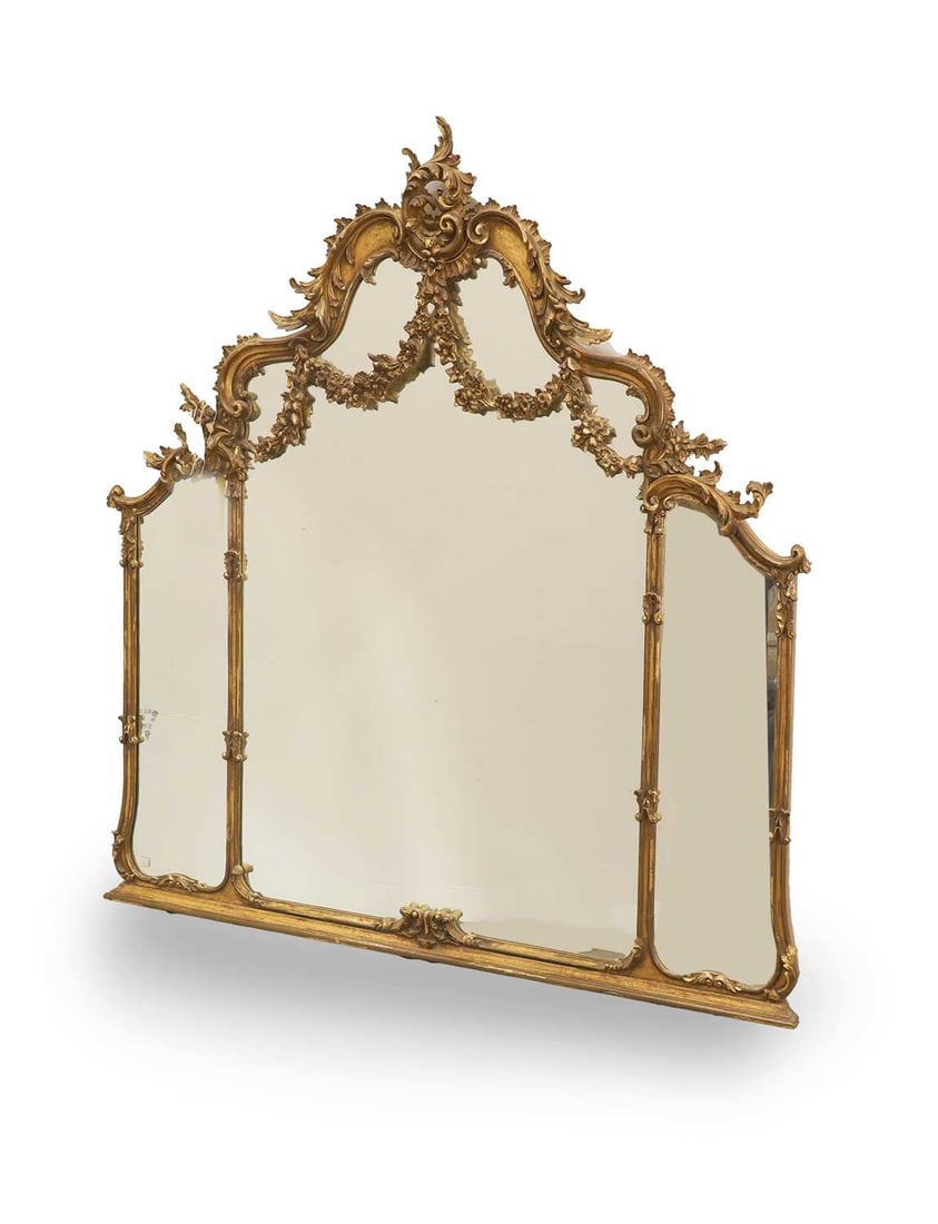 A carved giltwood and composition overmantel mirror, 20th century,: A carved giltwood and composition overmantel mirror, 20th century, triple plate with bevelled edge, with floral motif swags 127cm wide, 133cm high