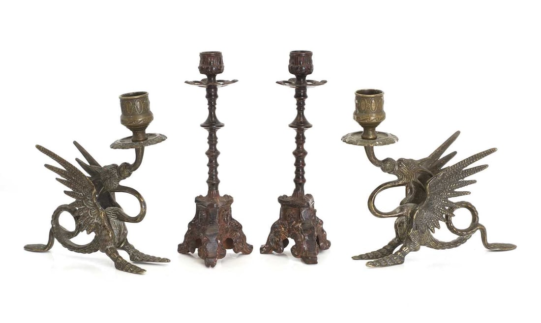 A pair of dragon candlesticks, 19th century and later,: A pair of dragon candlesticks, 19th century and later, depicted as seated, with a curling tail acting as a handle, together with a cast metal pair of Italianate candle sticks, with cherub masks 22cm h