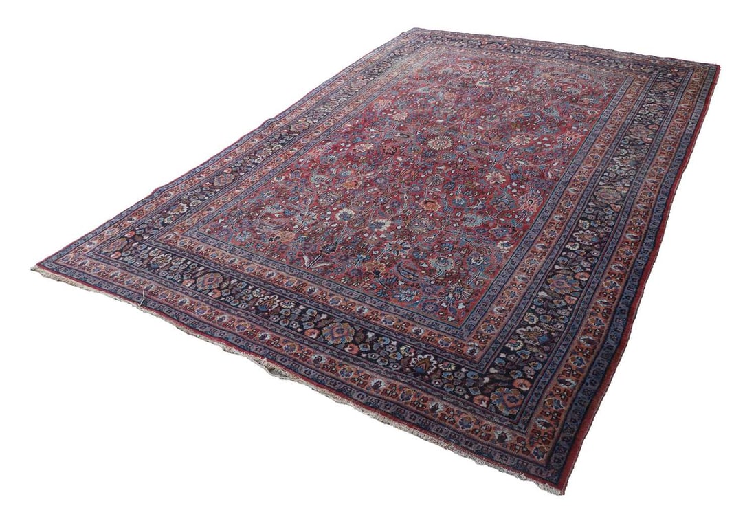 A Persian rug,: A Persian rug, red fields with all over foliate decoration and multi border 228cm wide, 310cm long Condition Report: Wear in areas and tassels cut down. Thin in some places. Repair to the corner