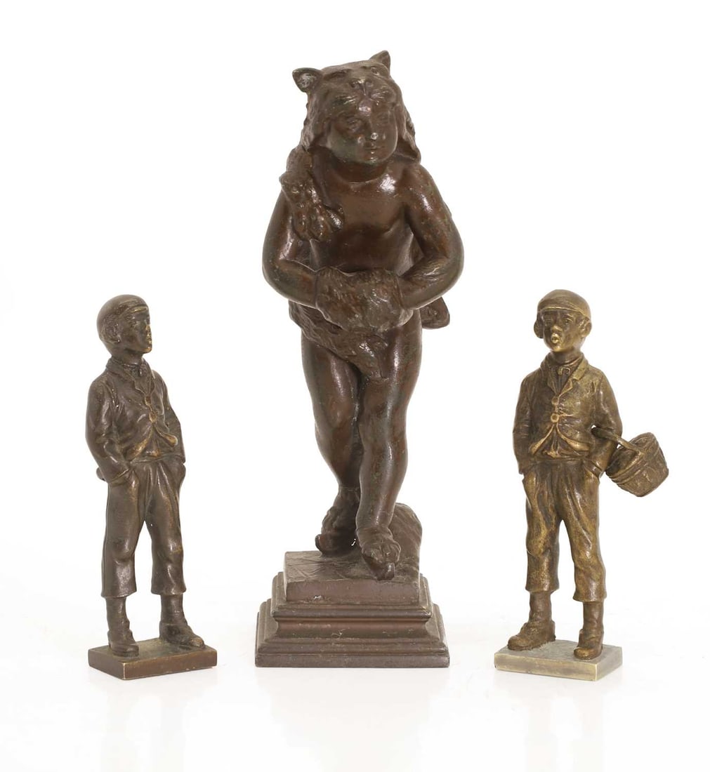 A pair of Austrian bronze figures,: A pair of Austrian bronze figures, modelled as two young boys, one with a loose basket inscribed on the back 'Thiermann', whistling, together with another example of a child on an animal bike, on squa