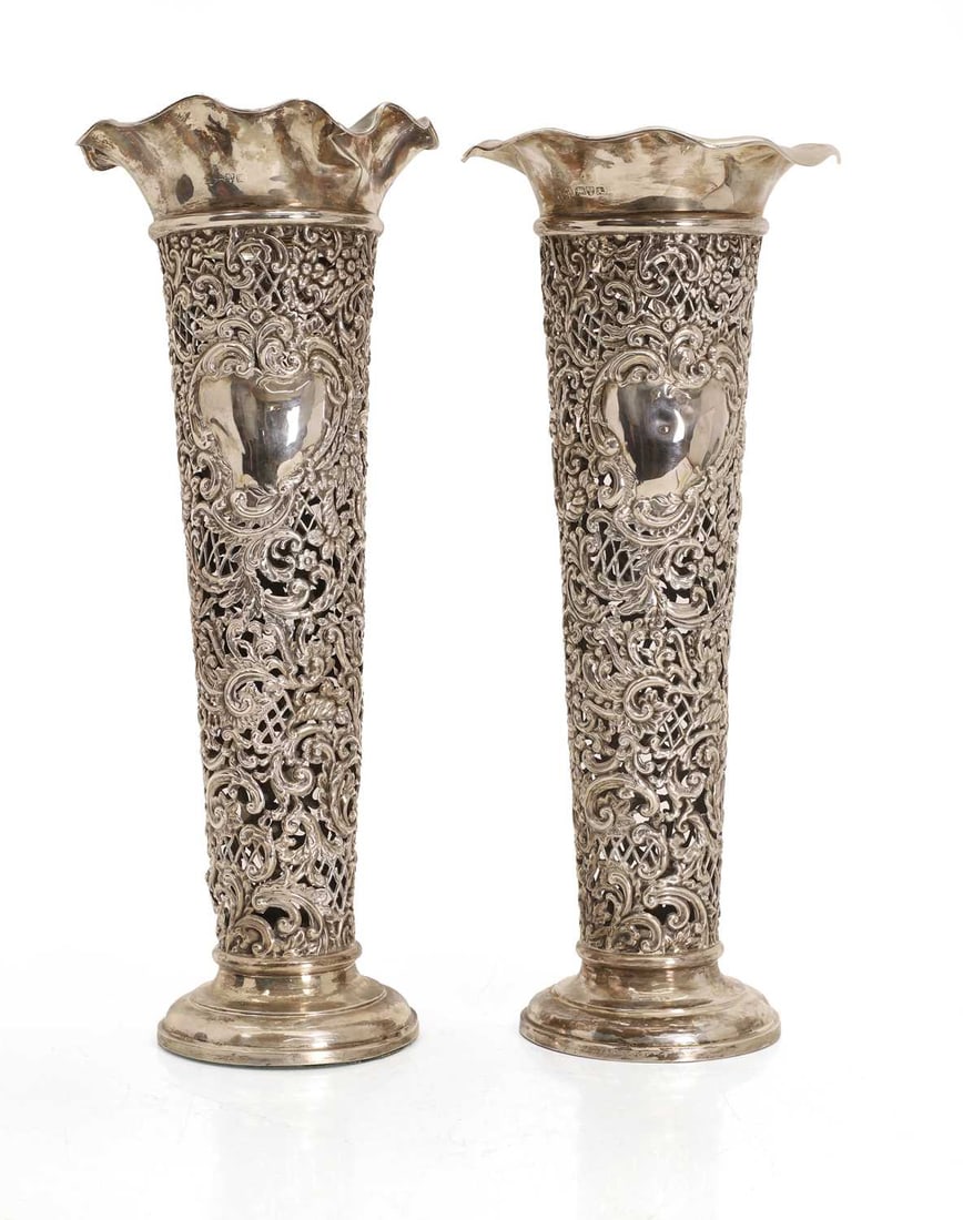A pair of silver spill vases,: A pair of silver spill vases, possibly by Henry Matthews, Chester, 1901, with a pierced column with vacant cartouches to the center and fluted rims, filled 17cm wide, 41cm high, total 74.9ozt 2