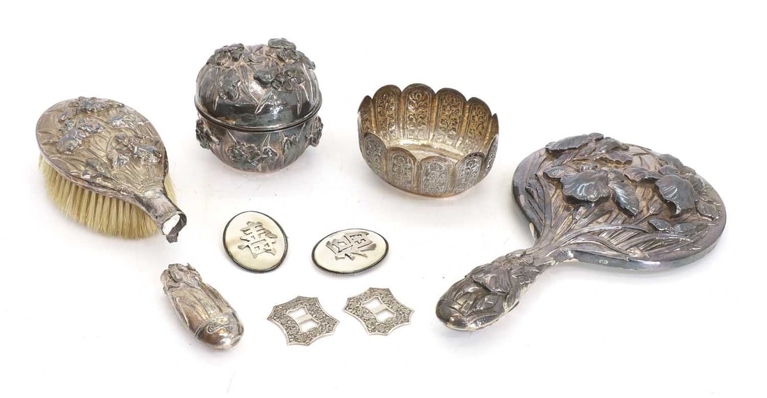 A Chinese Export silver-mounted dressing table set, circa 1900,: A Chinese Export silver-mounted dressing table set, circa 1900, embossed with irises, with impressed character marks, a pair of silver and mother-of-pearl brooches, a pair of pierced buckles and and a