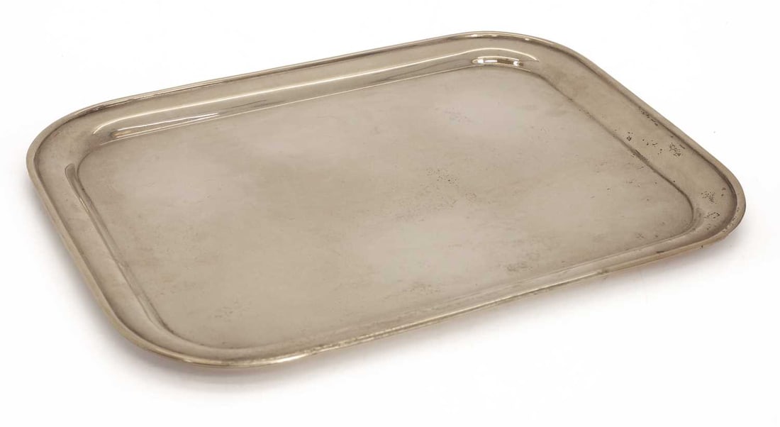 A rectangular silver serving tray,: A rectangular silver serving tray, by 'A&EV', Birmingham, 1923, with a raised rounded border 36cm wide, 27.5cm deep 23.2ozt