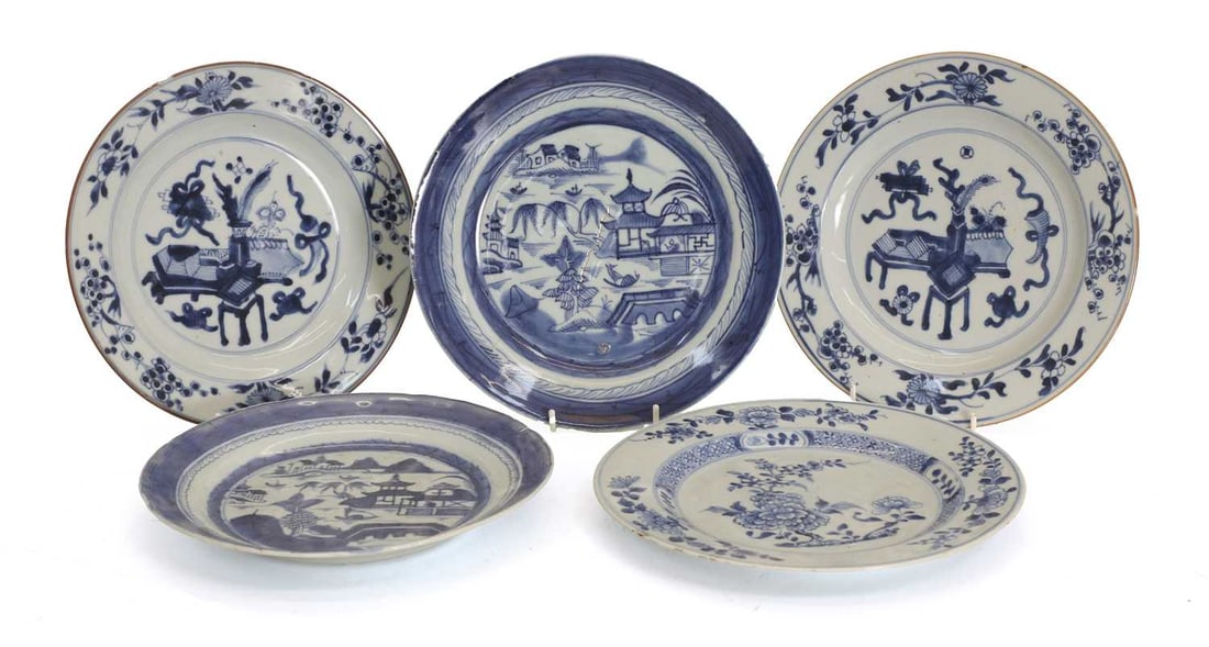 Five Chinese blue and white plates, 19th century and later,: Five Chinese blue and white plates, 19th century and later, decorated with prunus, a landscape and a chaise and table with objects largest 23.5cm diameter 5 Condition Report: Chips to the edges.