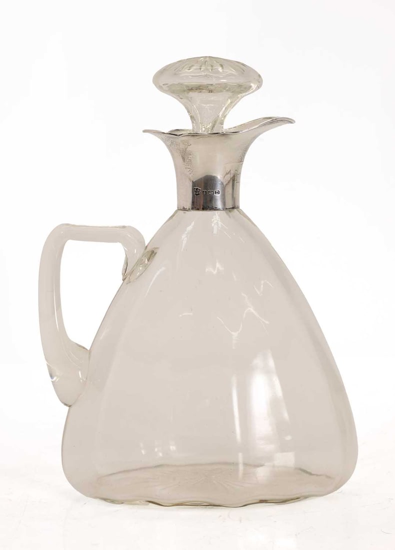 A George V silver mounted ewer,: A George V silver mounted ewer, by Barker Brothers Silver Ltd, Birmingham, 1928, the glass body of tapering form, with angular handle 17cm wide, 23.5cm high 2 Condition Report: Some minor
