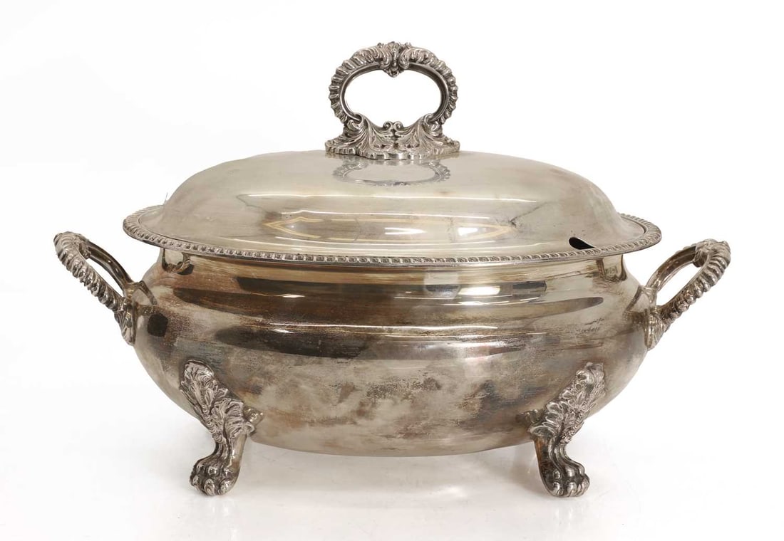 A silver lidded tureen dish,: A silver lidded tureen dish, by C J Vander Ltd, Sheffield, 1964, with floiate scrolled handle and side handles, terminating on lion paw feet 37cm wide, 25cm high, approximately 99.2ozt 2 Cond