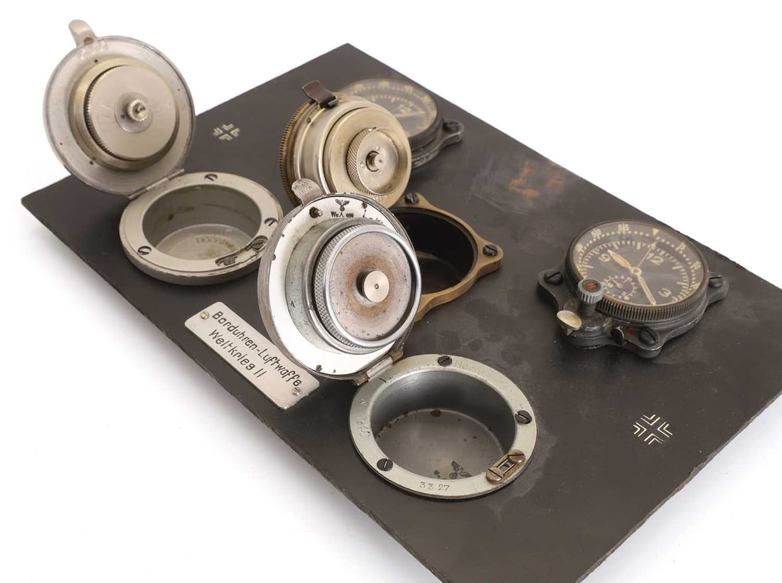 A board containing five examples of aircraft instrument clocks,'Borduhren Luftwaffe Weltkrieg II' 19 - 3