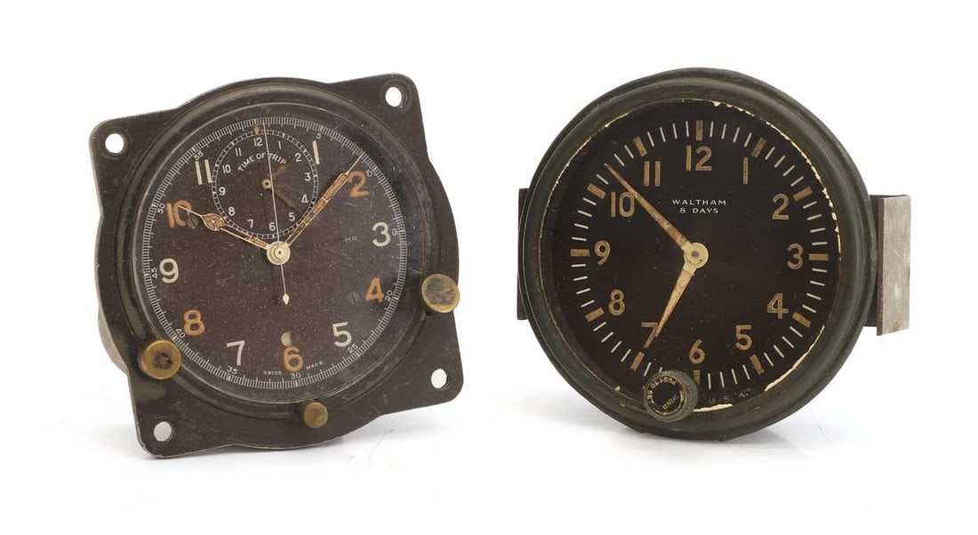 Two WWII clocks,: Two WWII clocks, an aircraft instrument clock, with a black dial and subsidiary 'Time of Trip' dial, and a Waltham 8-Day staff car or tank clock 9.5cm diameter and 10cm diameter 2 Provenance: The