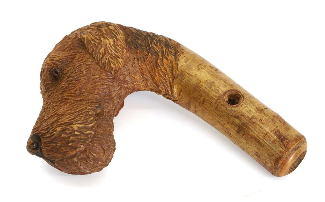 A Scottish terrier's head walking stick handle, 20th century,: A Scottish terrier's head walking stick handle, 20th century, in the manner of Swaine & Adeney, with glass eyes 4cm wide, 8.5cm deep, 11.5cm high, Condition Report: Some wear to the snout.