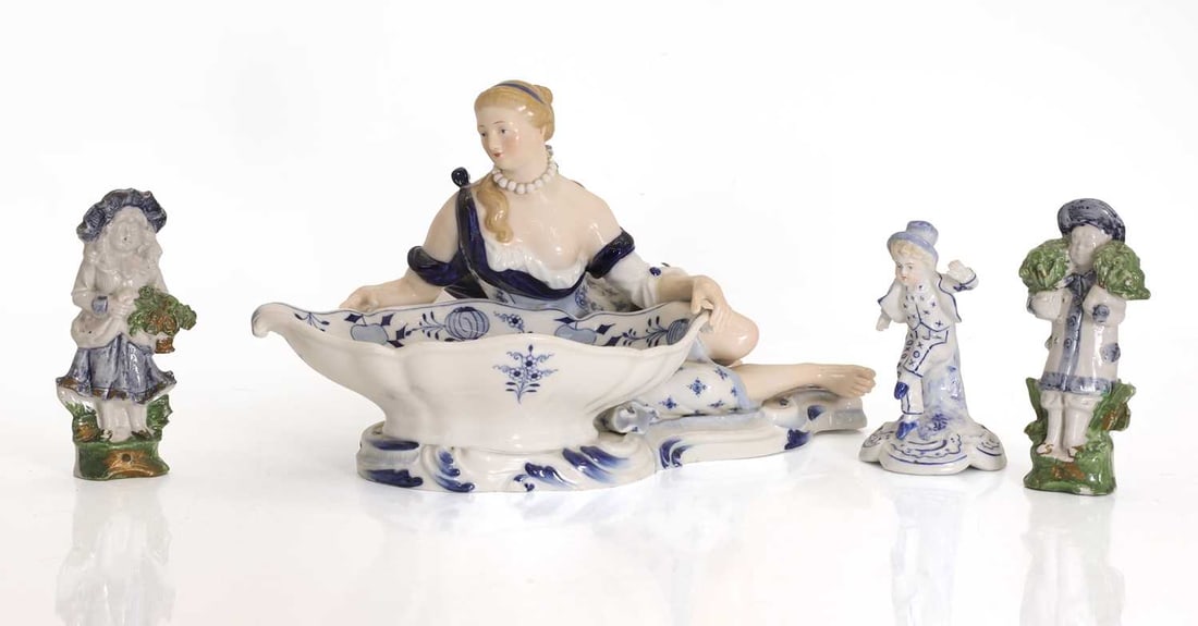 A Meissen sweet meat dish figure, 19th century and later,: A Meissen sweet meat dish figure, 19th century and later, onion pattern, the reclined figure behind a dish, marks to underside, together with two hand painted figures, of a boy and girl and a
