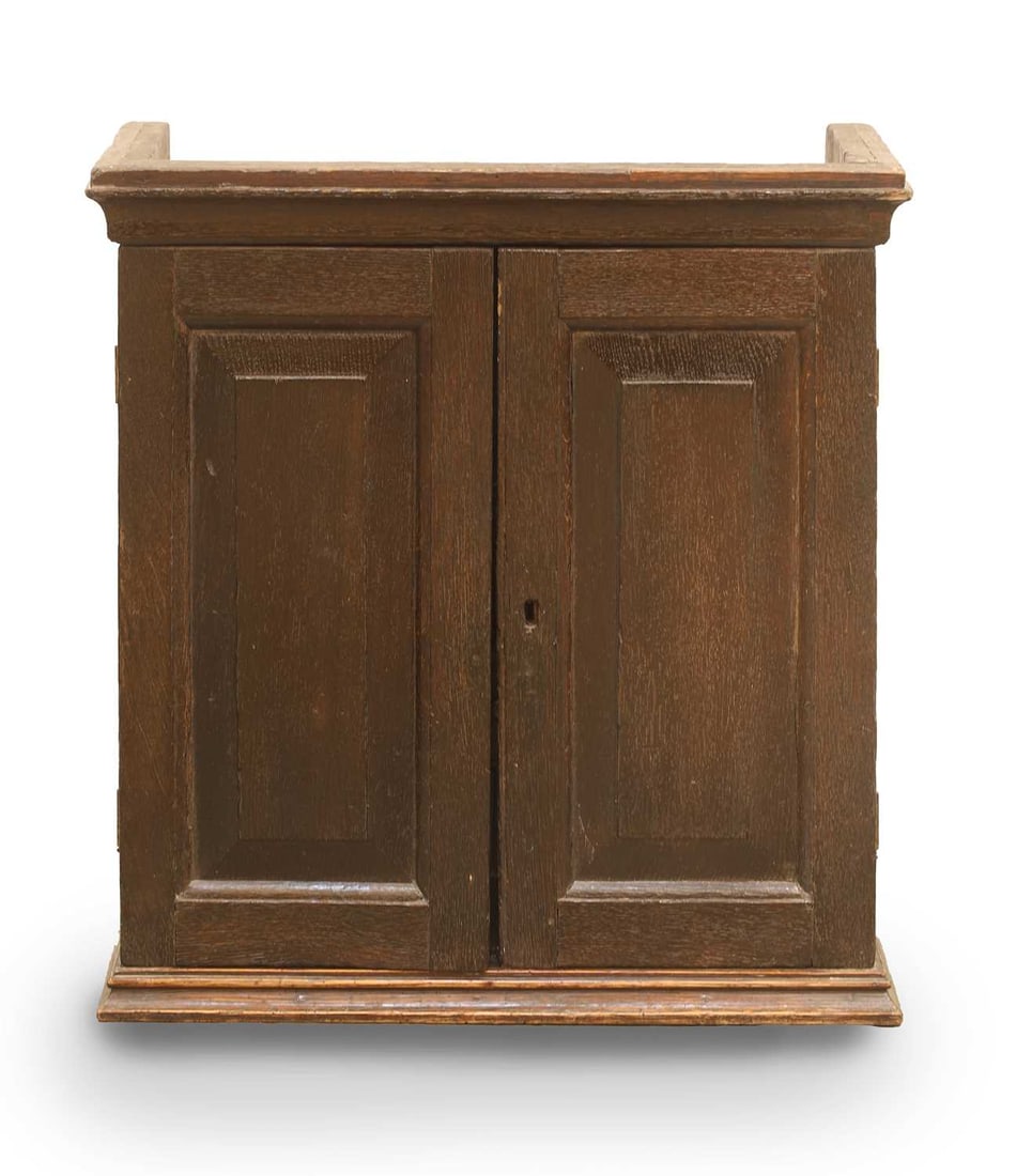 An oak spice cupboard, circa 1700,: An oak spice cupboard, circa 1700, with a fitted interior comprising of small drawers 55cm wide, 23cm deep, 57cm high Condition Report: marks, knocks, aged splits
