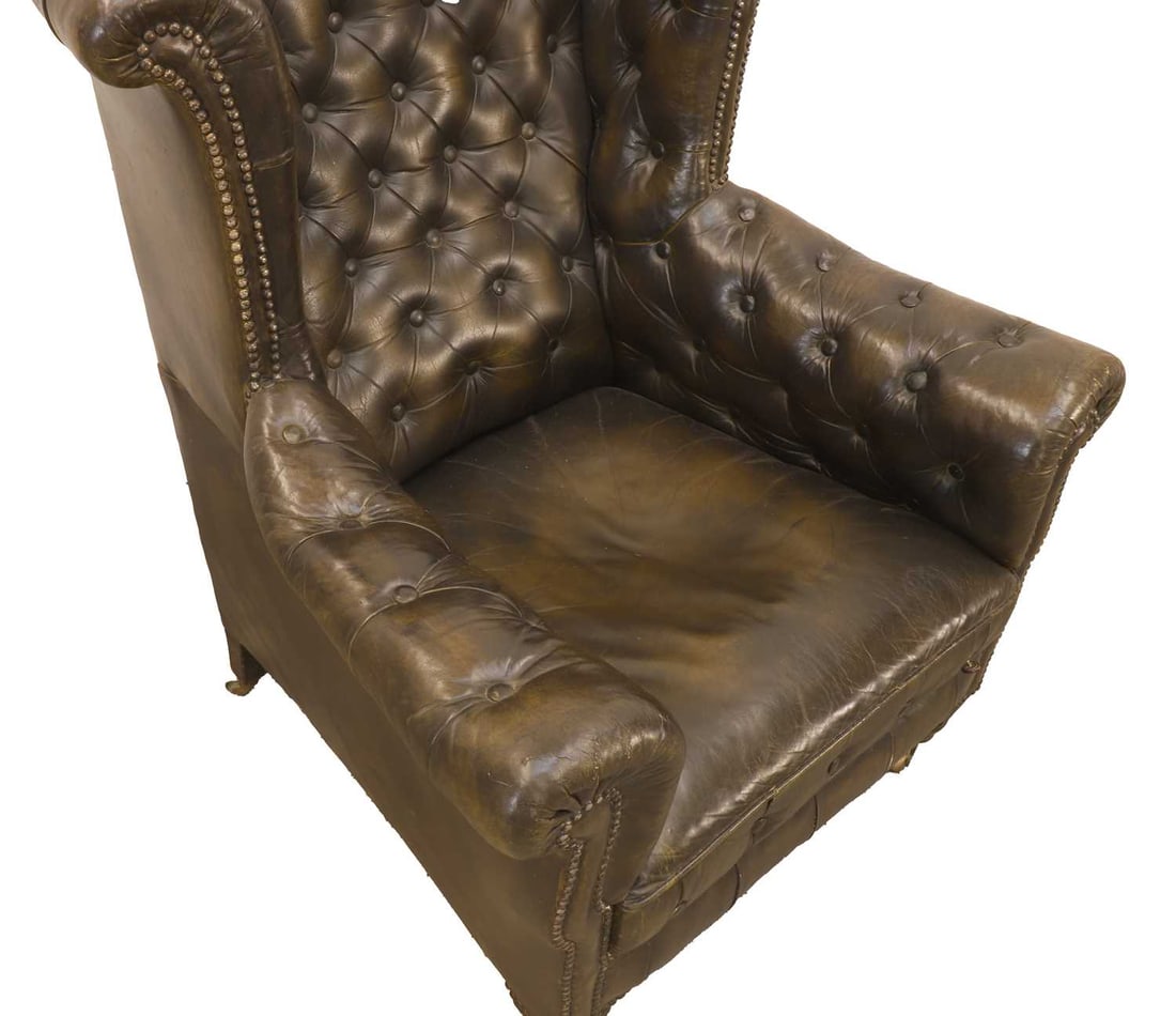 A buttoned upholstered wing back library armchair, 19th century, - 2
