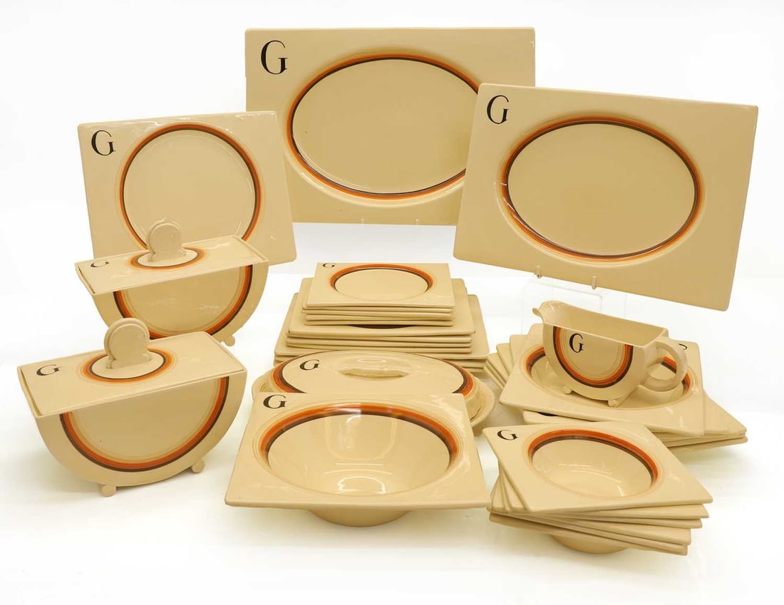 A collection of Clarice Cliff Bizarre dinnerwares, 1930s, each piece banded and with 'G',: A collection of Clarice Cliff Bizarre dinnerwares, 1930s, each piece banded and with 'G', comprising two lidded tureens, a gravy boat, four square plates, four rectangular plates, six soup bowls, six