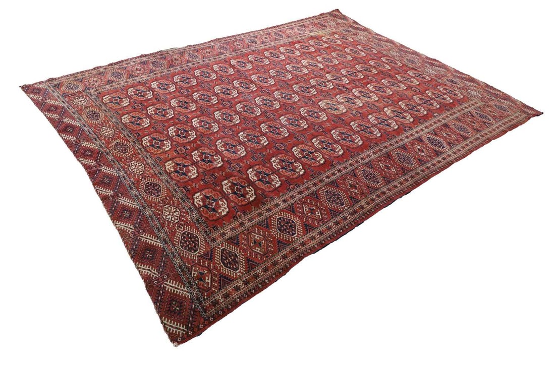 A Turkoman red ground rug, circa 1880,: A Turkoman red ground rug, circa 1880, of traditional design, with repeating medallions to the center encased in a triple border 323 x 235cm Condition Report: Some yelllow staining to one corner.