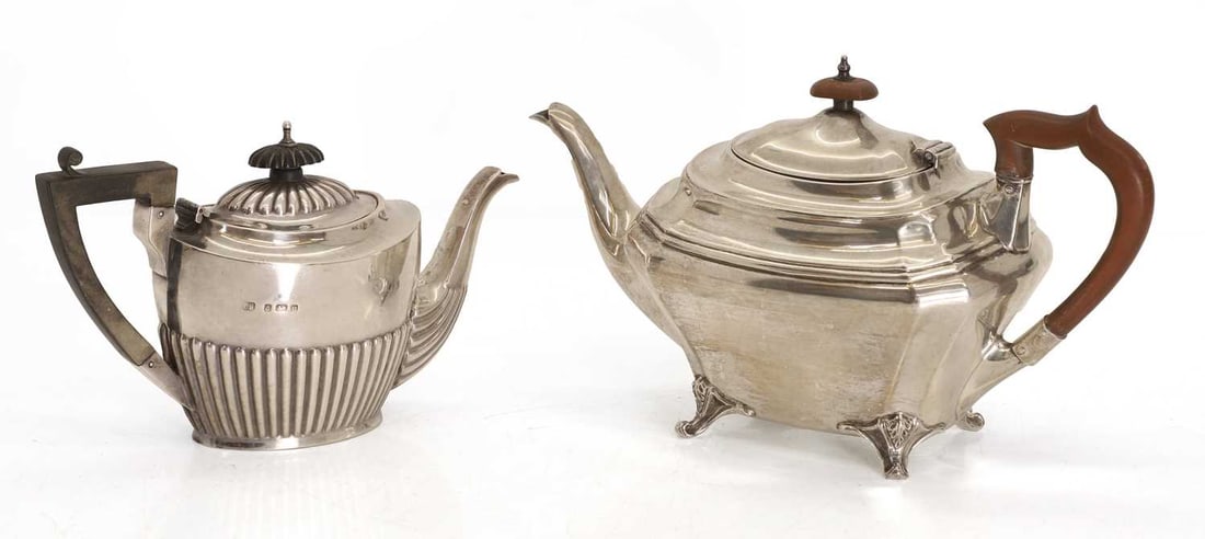 Two silver teapots,: Two silver teapots, by James Deakin & Sons (John & William F Deakin), Sheffield, 1922, with scrolled feet and wooden handle and finial, together with another teapot by Charles Horner (probably