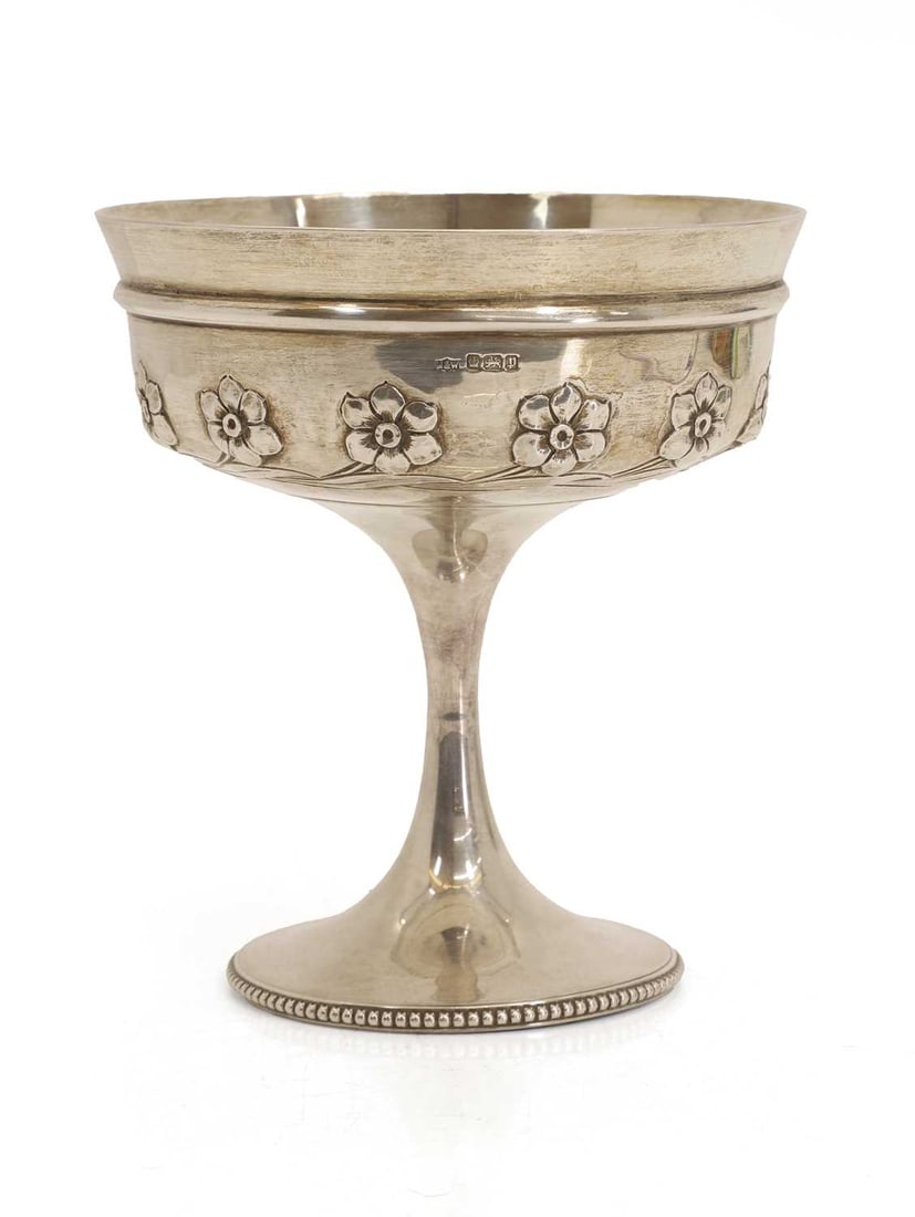 A silver tazza,: A silver tazza, by Mappin & Webb, Sheffield, 1907, decorated with flowers and with a beaded basal rim 15.3cm wide, 14.9ozt