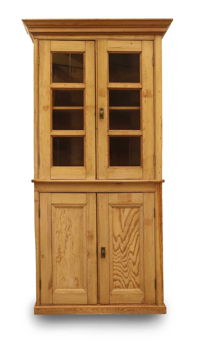 A Continental pine bookcase, late 19th century,: A Continental pine bookcase, late 19th century, having pair of glazed panel doors above cupboards on plinth base 95cm wide, 37cm deep, 214cm high