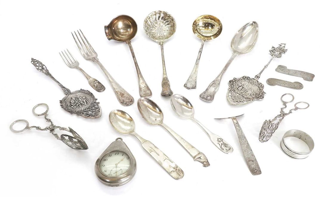 A collection of silver flatware,: A collection of silver flatware, mostly Scandinavian, to include two pairs of asparagus tongs, a sugar spoon, a table spoon with a shell motif on the handle, together with some silver plate and white