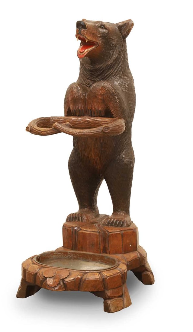 A Black Forest carved bear stick stand, late 19th century,: A Black Forest carved bear stick stand, late 19th century, modelled stand with glass eyes, a painted mouth, snout and claws, with a naturalistic mounted collar, and boulder stand, with a metal tray