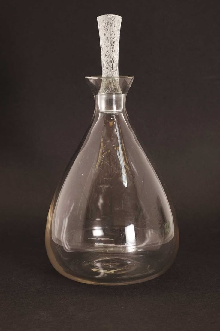 A Lalique decanter and stopper, circa 1927,: A Lalique decanter and stopper, circa 1927, in the Phalsbourg pattern, the square stopper with moulded decoration, and etched signature 25cm high Condition Report: Good condition