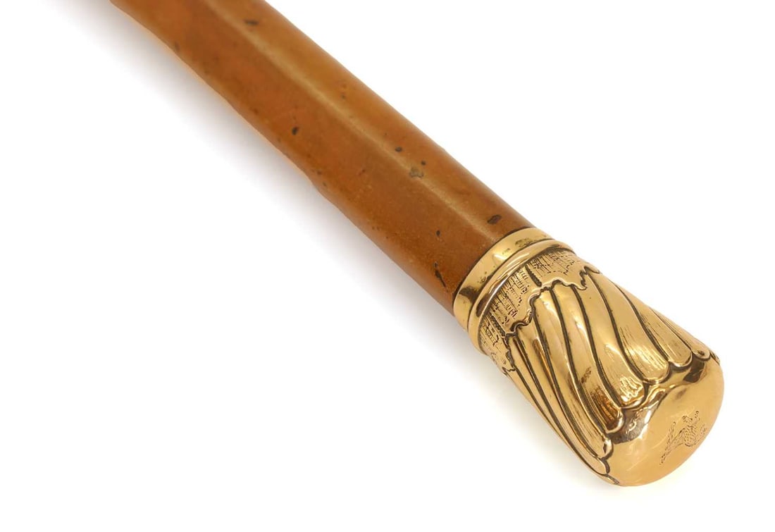 An 18ct gold-mounted walking cane, makers mark TJ, London 1888, - 2