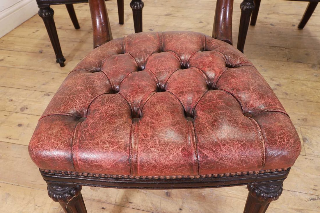A set of six mahogany and buttoned-leather dining chairs, 19th century and later, - 2