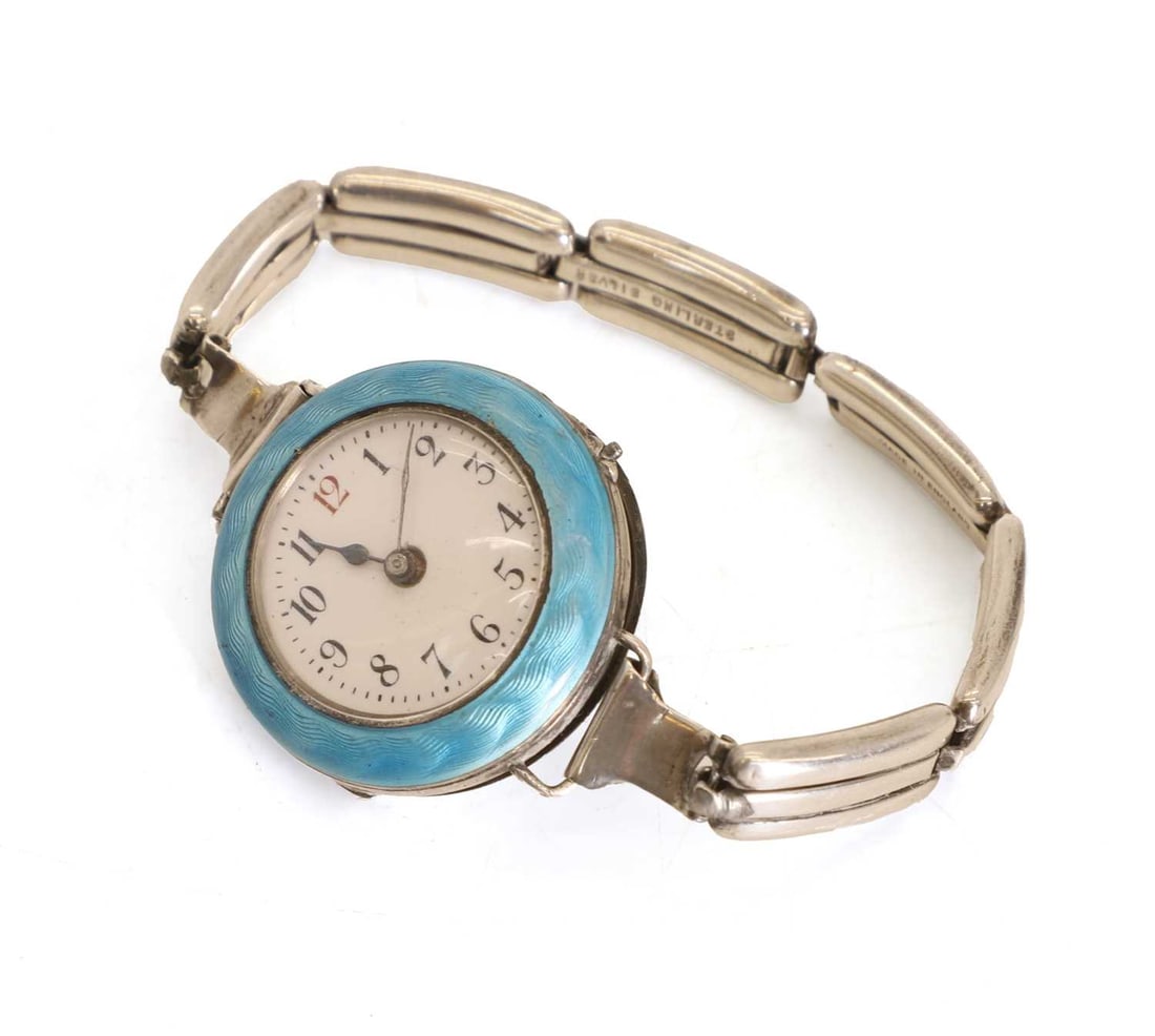 A ladies silver and guilloché enamel wristwatch, circa 1920,: A ladies silver and guilloché enamel wristwatch, circa 1920, with an enamel dial and engraved back plate on a silver expanding bracelet Dial, 3cm diameter, total 0.9ozt Condition Report: