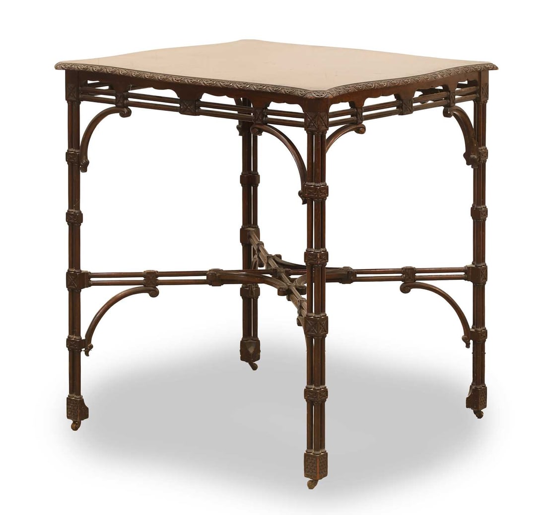 A Chippendale style mahogany occasional table, circa 1890, by Edwards & Roberts,: A Chippendale style mahogany occasional table, circa 1890, by Edwards & Roberts, the squared serpentine top with floral moulding, raised on cluster columns supports united by a stretcher, partial