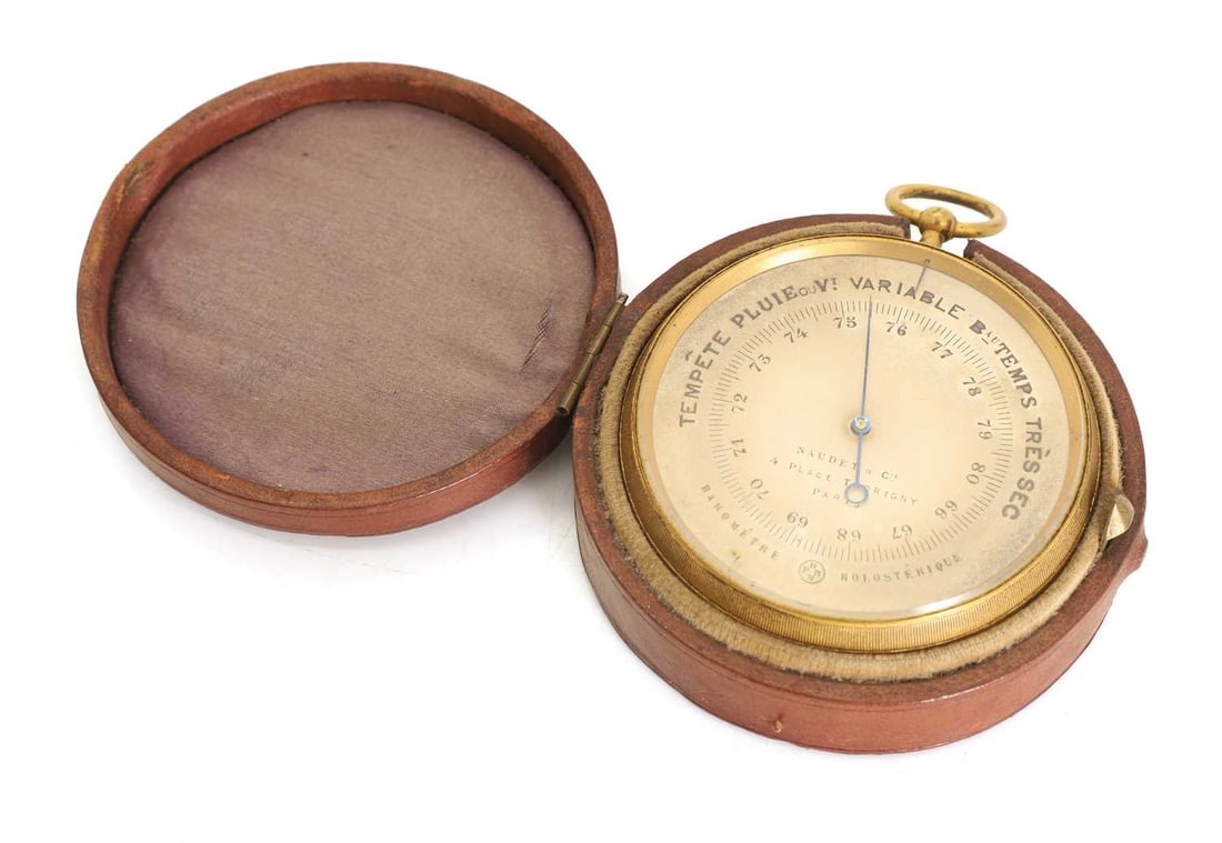 A French gilt metal pocket barometer, circa 1880,: A French gilt metal pocket barometer, circa 1880, by Naudet & Cie, 4 Place Thorigny, Paris, stamped 'HPBN' to the back of the case, in a red leather case 6cm diameter 2 Condition Report: Good