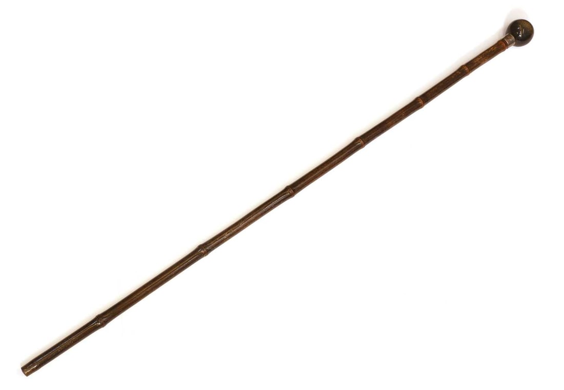 A horn and silver-mounted walking cane, makers mark C.C., London, 1909?, stamped Brigg London,: A horn and silver-mounted walking cane, makers mark C.C., London, 1909?, stamped Brigg London, the turned horn ball pommel, with a silver collar, a bamboo shaft with a metal ferrule 90cm long