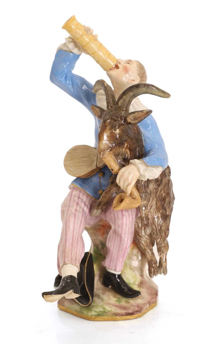 A Meissen figure of Harlequin, 19th century,: A Meissen figure of Harlequin, 19th century, modelled as a seated gentleman drinking from a 'pass glass' beside a goat, their hat on the floor, blue swords to underside as well as insised marks