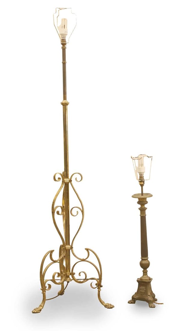 A brass standard lamp, 20th century,: A brass standard lamp, 20th century, adjustable, with scrolled support and terminating in lion paw feet, together with another column lamp with reeded column and terminating with lion paw feet