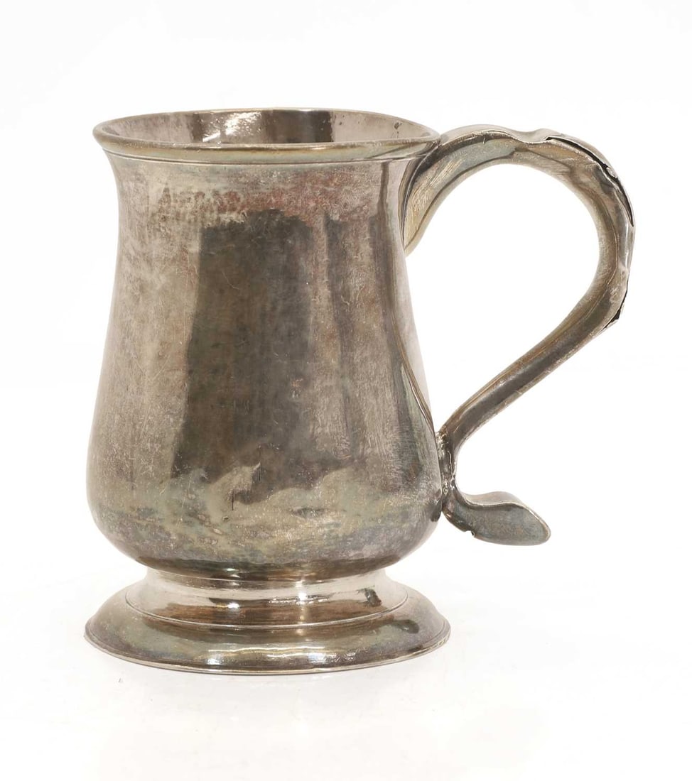 A silver tankard,: A silver tankard, Newcastle, 1759, stamped marks to the base, initialled on the handle 'L D' 13.5cm wide, 13cm high, 10.4ozt Condition Report: Handle broken and dented.