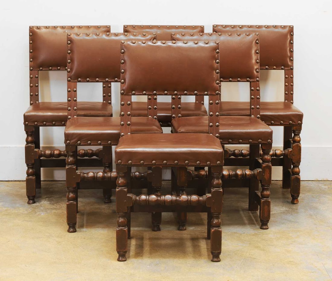 A set of six oak dining chairs, 19th century,: A set of six oak dining chairs, 19th century, with faux brown leather and studded upholstered seats and backs, the turned front legs and stretchers united with square back supports 47cm wide, 42cm