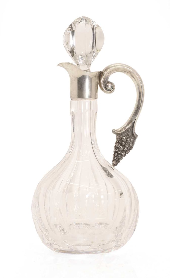 An Elizabeth II silver mounted claret jug,: An Elizabeth II silver mounted claret jug, by Harrison Brothers & Howson Ltd, London, 1973, the faceted glass body with applied silver mounts, the handle cast with a bunch of grapes, hallmarked 13