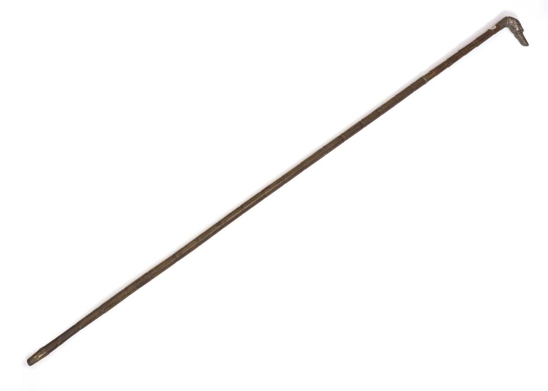 A silver-mounted dog's head walking cane, possibly by Thomas William Dee, London, 1897,: A silver-mounted dog's head walking cane, possibly by Thomas William Dee, London, 1897, with glass eyes, a Partridge wood shaft, and a brass ferrule 94cm long Condition Report: Fair overall, some